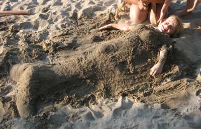 austin buried in sand shaped as a mermaid