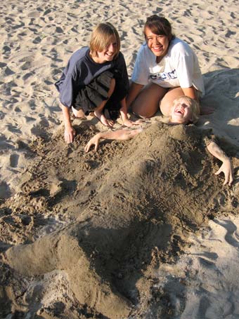 austin buried in sand buried as mermaid with Meghan and Midori