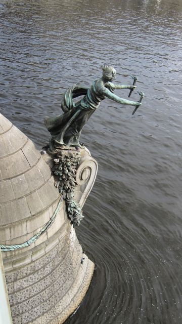 sculpture hanging off bridge