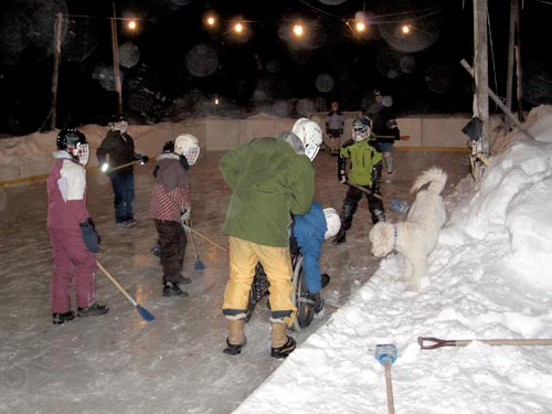 Jon digs the side of the boards on Paul's backyard rink