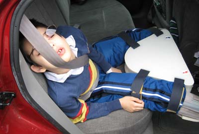 Jon sleeping against car seatbelt