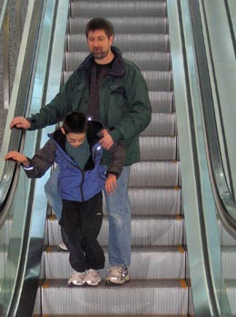 Jon and Daddy on escalator