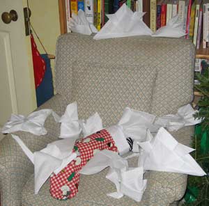 a chair with a stocking and many folded handkerchiefs on it
