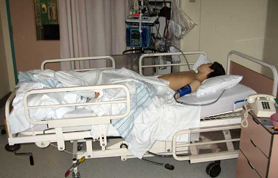 Jon in a hospital bed