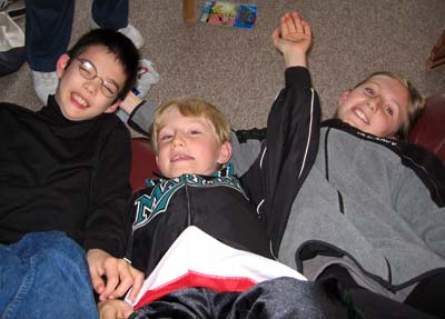 the three kids, lying back and goofing around